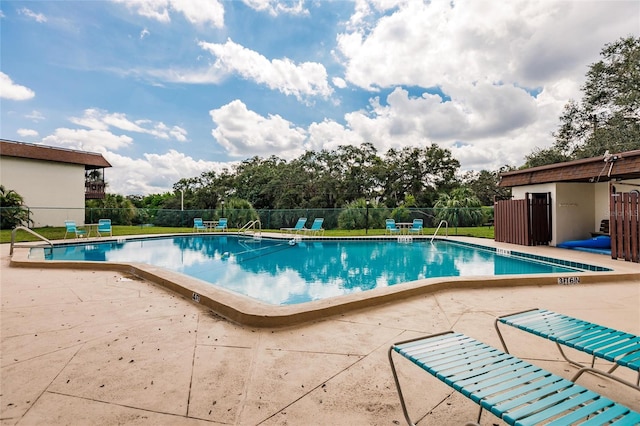 view of swimming pool with a patio area