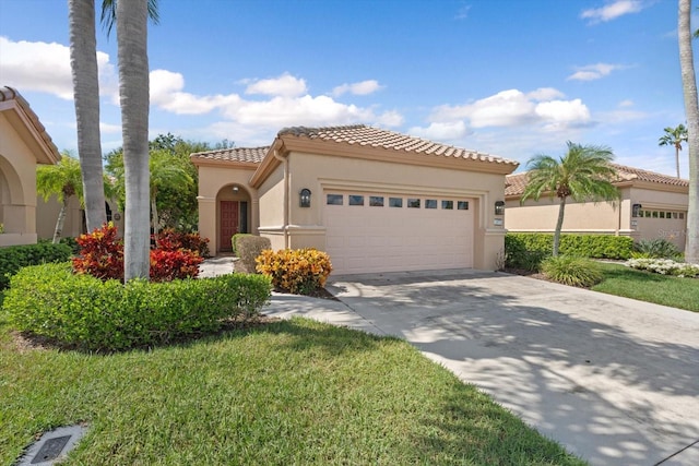 mediterranean / spanish house with a front yard and a garage