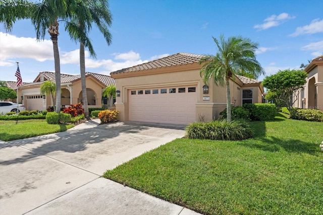 mediterranean / spanish-style home featuring a garage and a front lawn