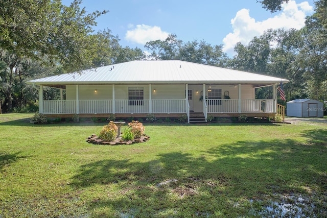 back of house featuring a porch, a lawn, and a storage unit