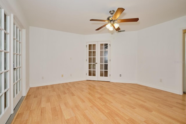 unfurnished room with ceiling fan, french doors, and light hardwood / wood-style flooring