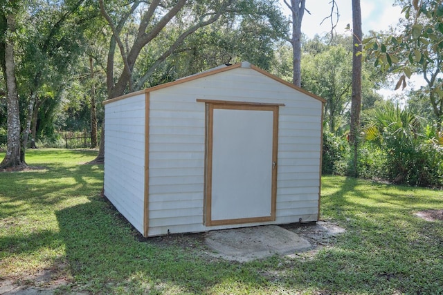 view of outdoor structure featuring a lawn