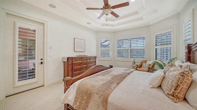 bedroom with access to outside, light carpet, a tray ceiling, crown molding, and ceiling fan