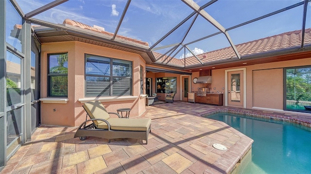 view of pool featuring area for grilling, a patio, and glass enclosure