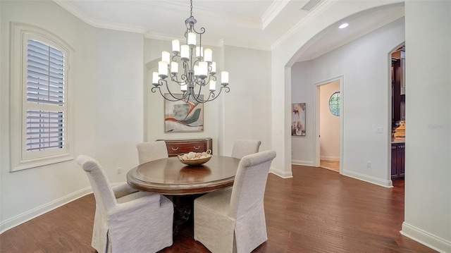 dining area with dark wood-style flooring, visible vents, arched walkways, baseboards, and a chandelier