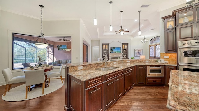 kitchen with ceiling fan, appliances with stainless steel finishes, a sink, dark wood-style floors, and glass insert cabinets