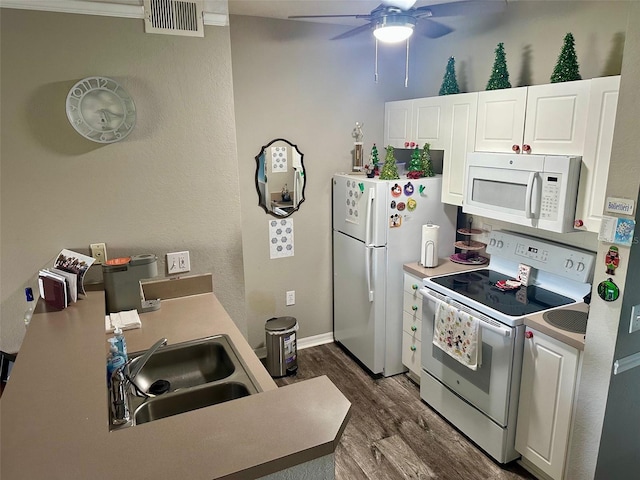 kitchen featuring white cabinetry, dark hardwood / wood-style floors, ornamental molding, sink, and white appliances