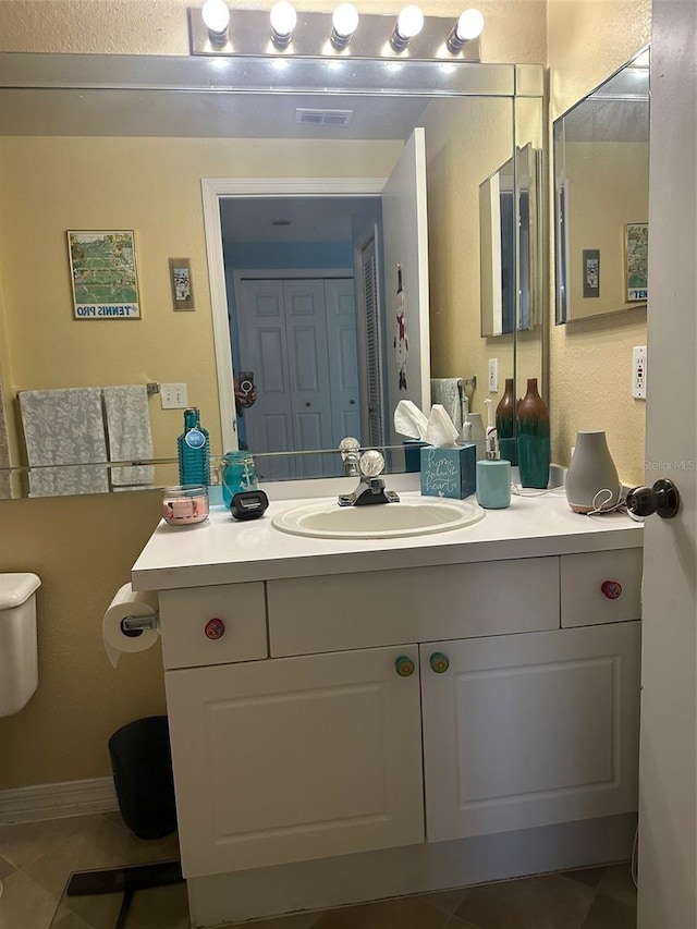 bathroom featuring vanity, toilet, and tile patterned floors