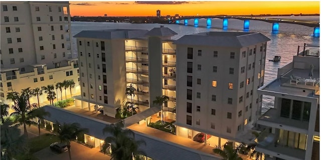 226 Golden Gate Pt Unit 64, Sarasota, FL 34236 - property at dusk with a water view