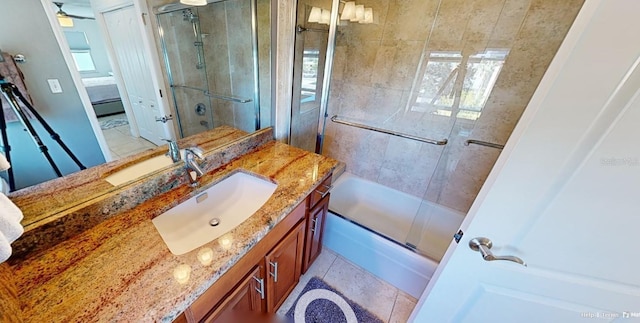 bathroom featuring bath / shower combo with glass door, vanity, and tile patterned flooring