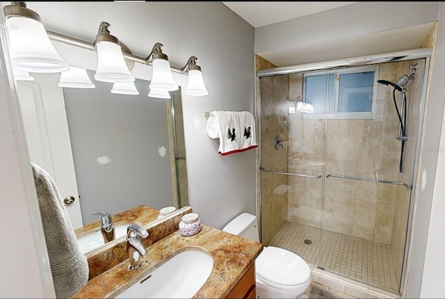 bathroom featuring toilet, walk in shower, and vanity