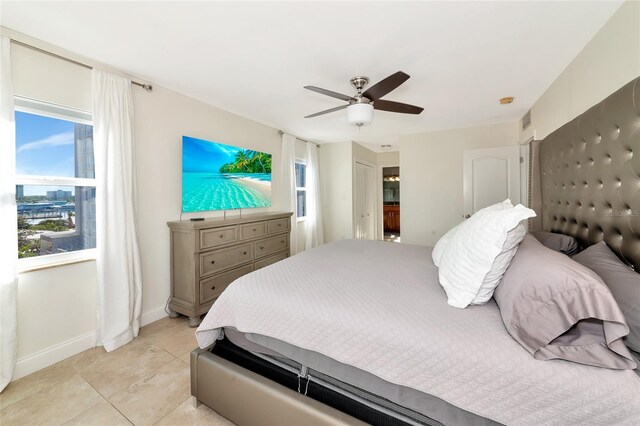 226 Golden Gate Pt Unit 64, Sarasota, FL 34236 - bedroom with ceiling fan, baseboards, multiple windows, and light tile patterned floors