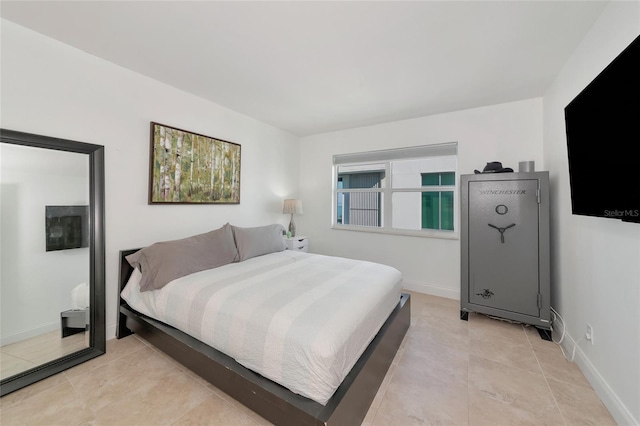 226 Golden Gate Pt Unit 64, Sarasota, FL 34236 - bedroom with baseboards and light tile patterned floors