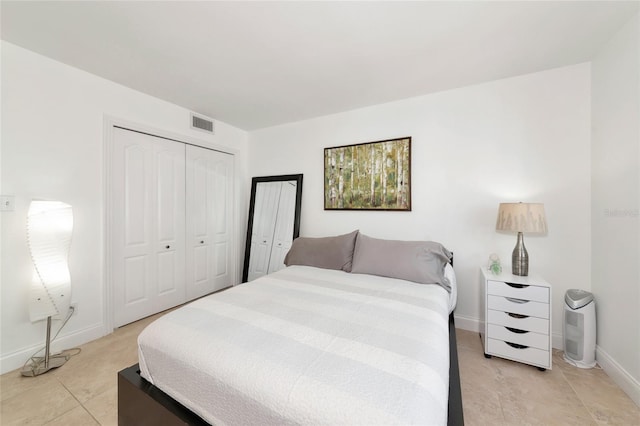 226 Golden Gate Pt Unit 64, Sarasota, FL 34236 - bedroom with visible vents, a closet, baseboards, and light tile patterned floors