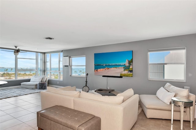 226 Golden Gate Pt Unit 64, Sarasota, FL 34236 - living room featuring visible vents, a water view, and light tile patterned floors