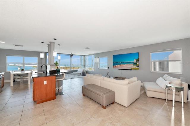 226 Golden Gate Pt Unit 64, Sarasota, FL 34236 - living room with plenty of natural light, visible vents, a water view, and light tile patterned flooring