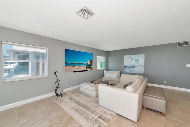226 Golden Gate Pt Unit 64, Sarasota, FL 34236 - living area featuring baseboards, light tile patterned flooring, and visible vents