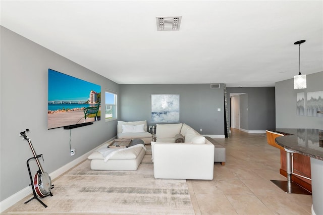 226 Golden Gate Pt Unit 64, Sarasota, FL 34236 - living area featuring baseboards, visible vents, and light tile patterned floors