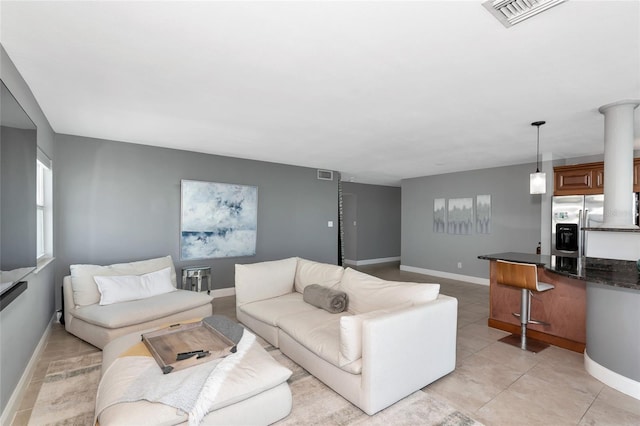226 Golden Gate Pt Unit 64, Sarasota, FL 34236 - living area with visible vents, baseboards, and light tile patterned floors