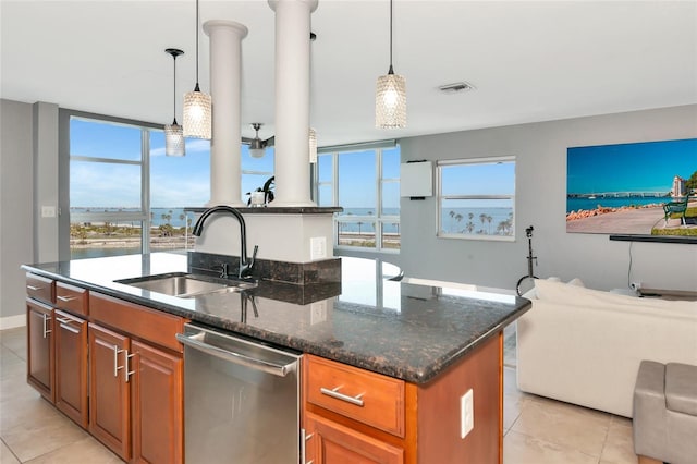 226 Golden Gate Pt Unit 64, Sarasota, FL 34236 - kitchen featuring dishwasher, a sink, light tile patterned flooring, brown cabinetry, and open floor plan