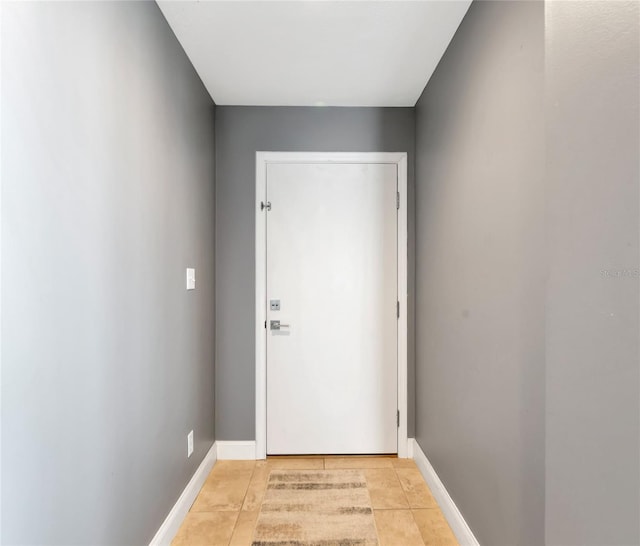 226 Golden Gate Pt Unit 64, Sarasota, FL 34236 - doorway to outside featuring light tile patterned flooring and baseboards