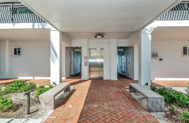 226 Golden Gate Pt Unit 64, Sarasota, FL 34236 - entrance to property featuring elevator and stucco siding