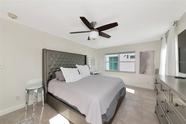 226 Golden Gate Pt Unit 64, Sarasota, FL 34236 - bedroom featuring a ceiling fan, baseboards, and light tile patterned floors