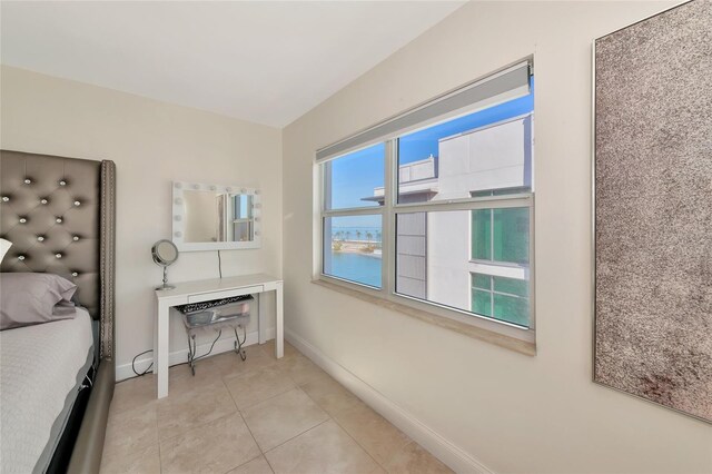 226 Golden Gate Pt Unit 64, Sarasota, FL 34236 - bedroom with baseboards and light tile patterned floors