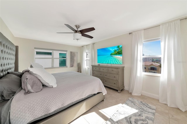 226 Golden Gate Pt Unit 64, Sarasota, FL 34236 - bedroom featuring ceiling fan, baseboards, and light tile patterned floors