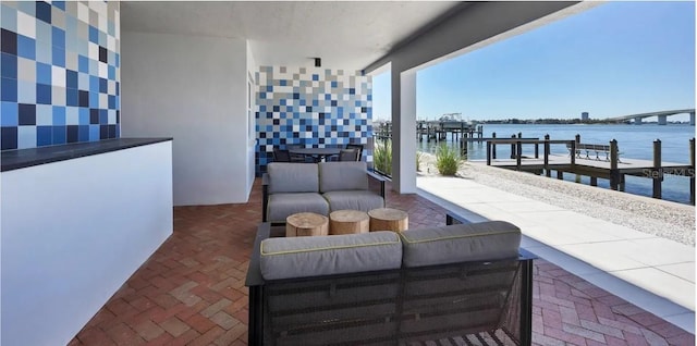 226 Golden Gate Pt Unit 64, Sarasota, FL 34236 - view of patio with an outdoor living space, a dock, boat lift, and a water view