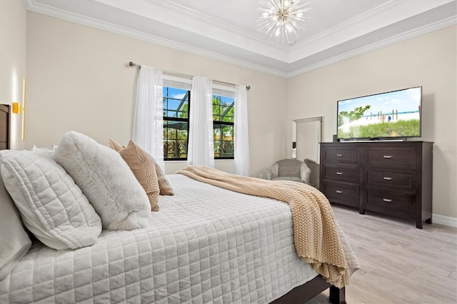 bedroom featuring baseboards, ornamental molding, light wood-type flooring, and an inviting chandelier