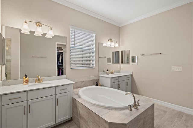 bathroom with a bath, crown molding, two vanities, and a sink