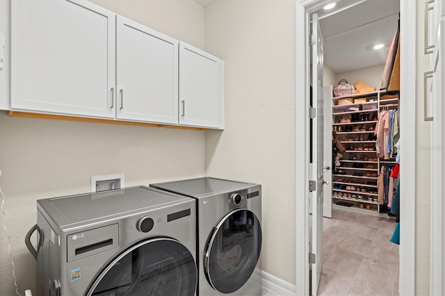 laundry room with cabinet space and separate washer and dryer