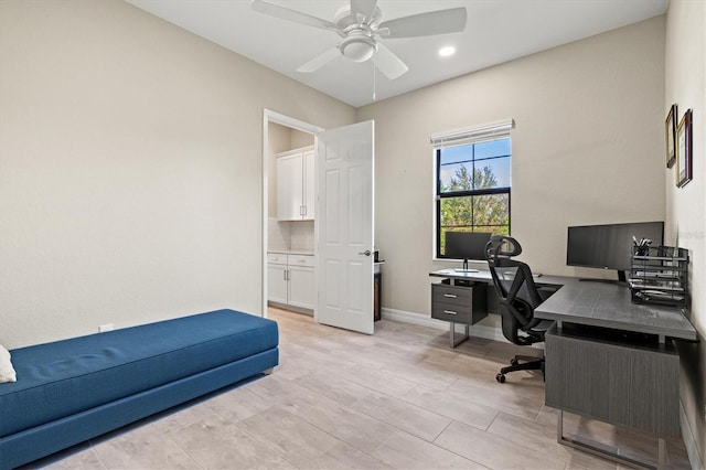 home office featuring a ceiling fan, light wood finished floors, and baseboards