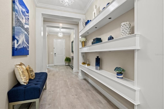 corridor with a chandelier, crown molding, and baseboards