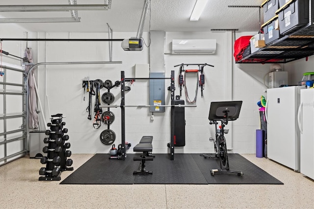 workout room featuring a textured ceiling, a garage, water heater, a wall mounted air conditioner, and concrete block wall