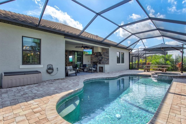 view of pool with glass enclosure, ceiling fan, a pool with connected hot tub, and a patio