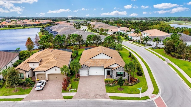 drone / aerial view with a water view and a residential view