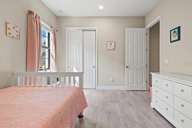 bedroom with a closet and baseboards