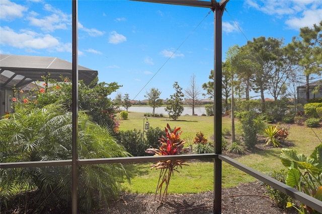 exterior space featuring glass enclosure and a water view