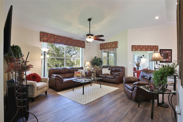 living room featuring lofted ceiling, ceiling fan, and dark wood-type flooring