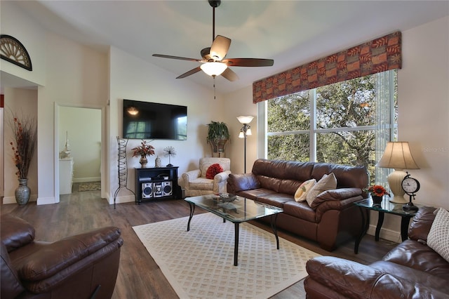 living room featuring dark hardwood / wood-style floors, vaulted ceiling, and ceiling fan