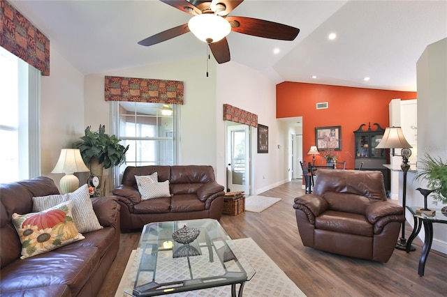 living room featuring ceiling fan, hardwood / wood-style flooring, and vaulted ceiling