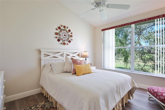 bedroom featuring ceiling fan, dark wood-type flooring, and vaulted ceiling