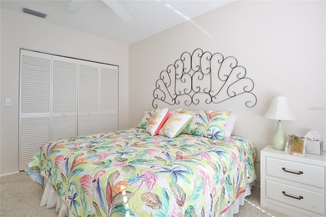 bedroom featuring light carpet, a closet, and ceiling fan