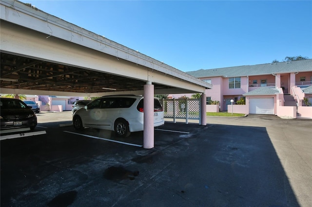 view of vehicle parking with a carport and a garage