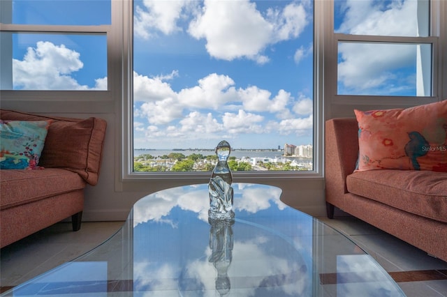 tiled dining space featuring a water view