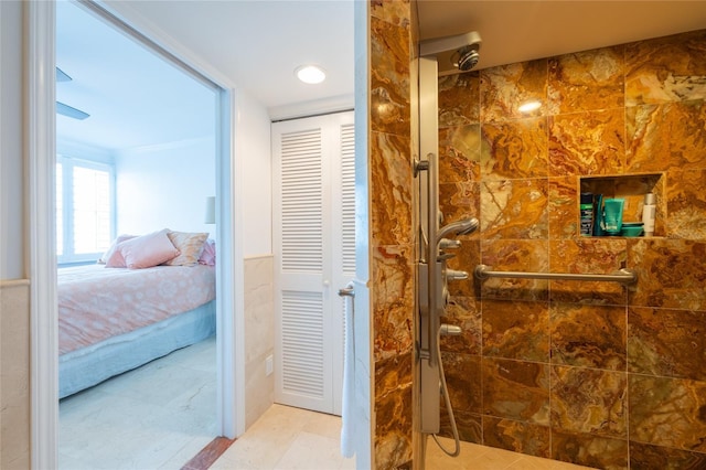 bathroom with crown molding, tile patterned floors, and a tile shower