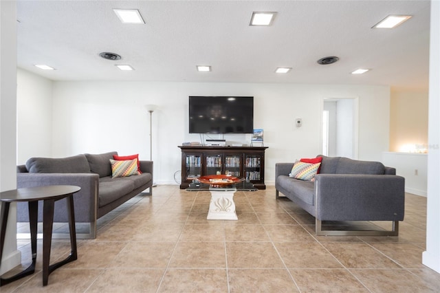 living room featuring light tile patterned floors and a textured ceiling