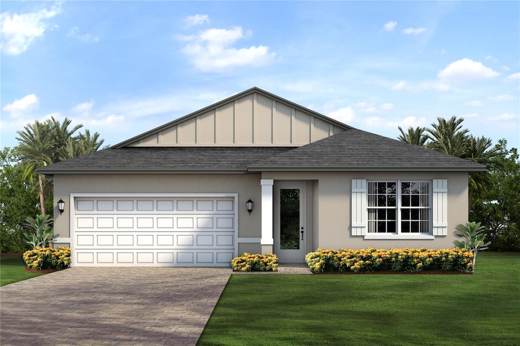 view of front of property featuring a front yard and a garage